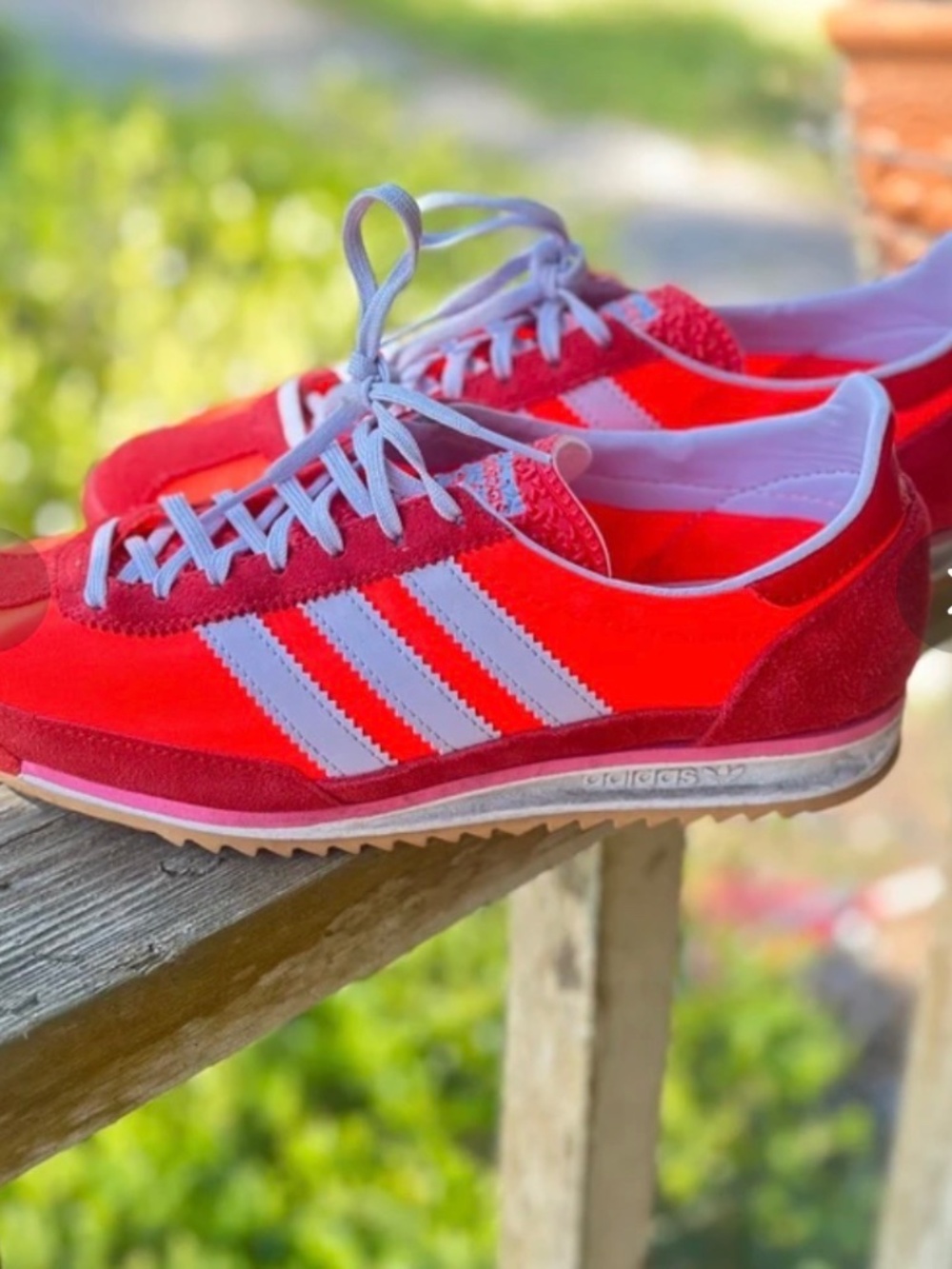 Bright red and purple Adidas sneakers